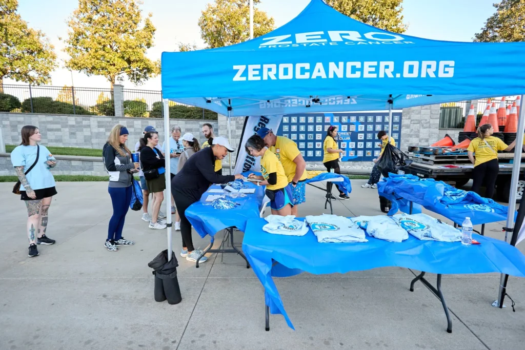 A branded merchandise tent at the ZERO Prostate Cancer Run/Walk event, 2025, sponsored by KCUC.