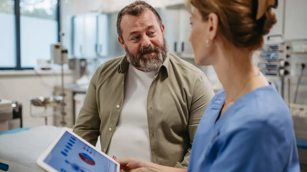 KCUC Physician discussing risk factors with a patient using educational materials